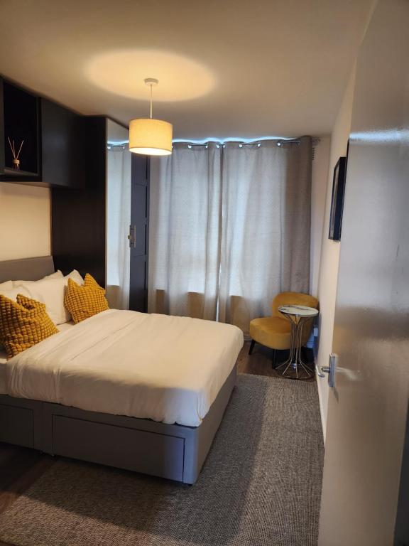 a hotel room with a bed and a table at Your home from home in London
