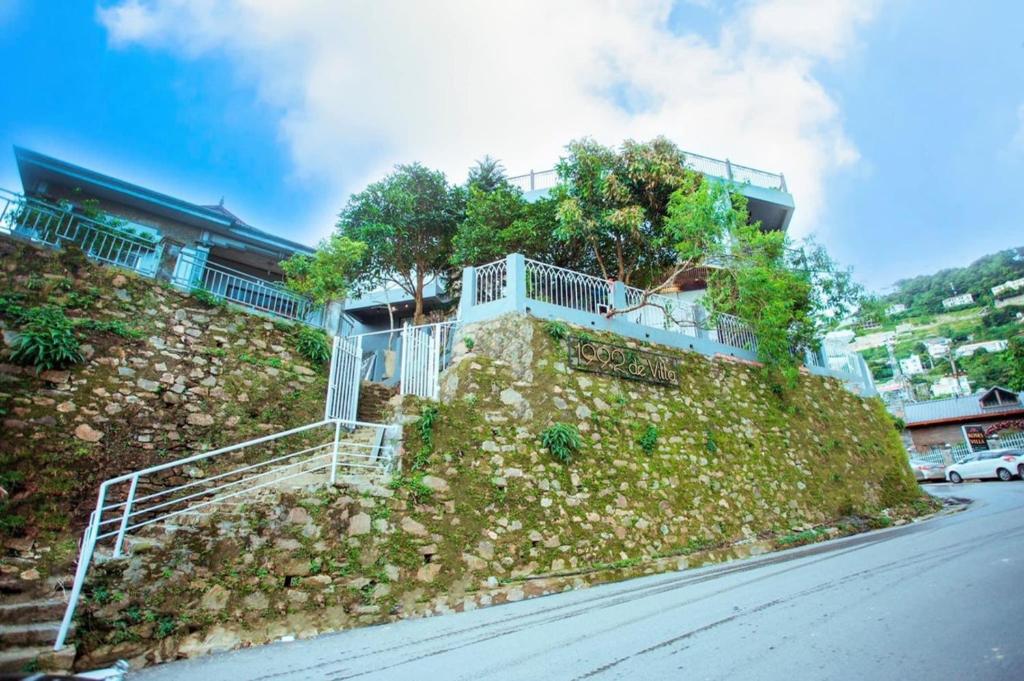 a house on the side of a hill with stairs at 1992 Tam Đảo - Venuestay in Tam Ðảo