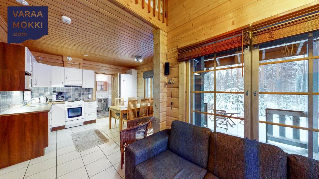 a living room with a couch and a kitchen at Himos Huili 2 in Himos