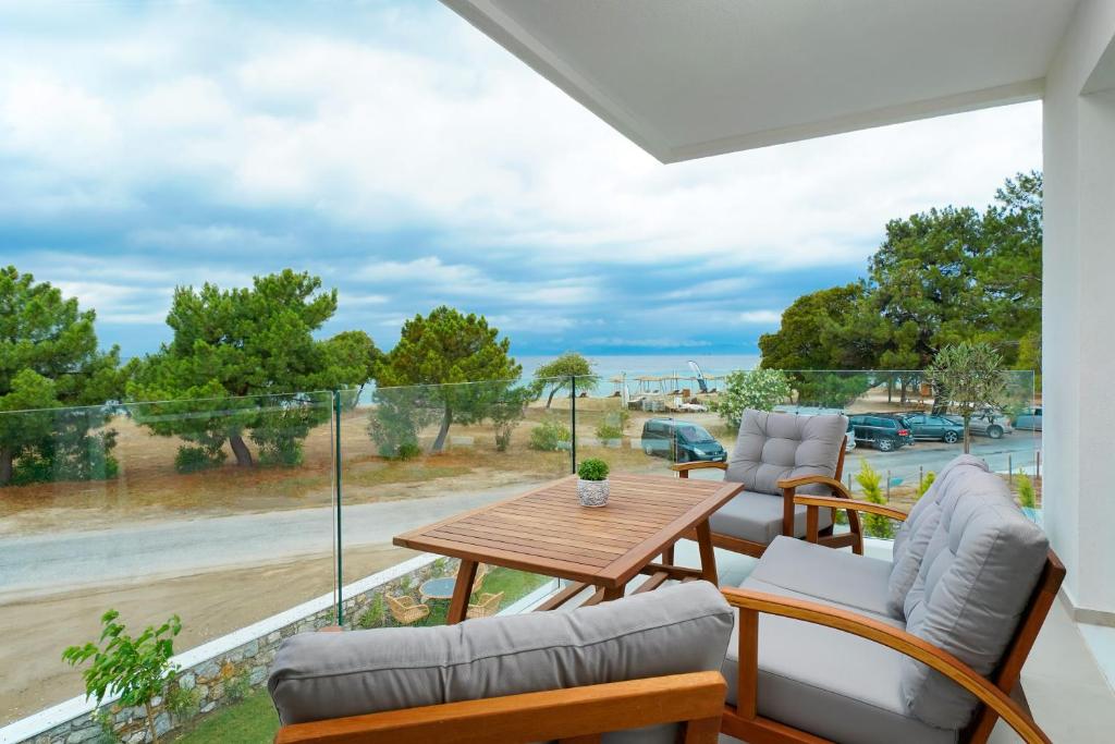 a patio with a table and chairs and a view of the ocean at Sentimento Sea Breeze in Skala Prinou