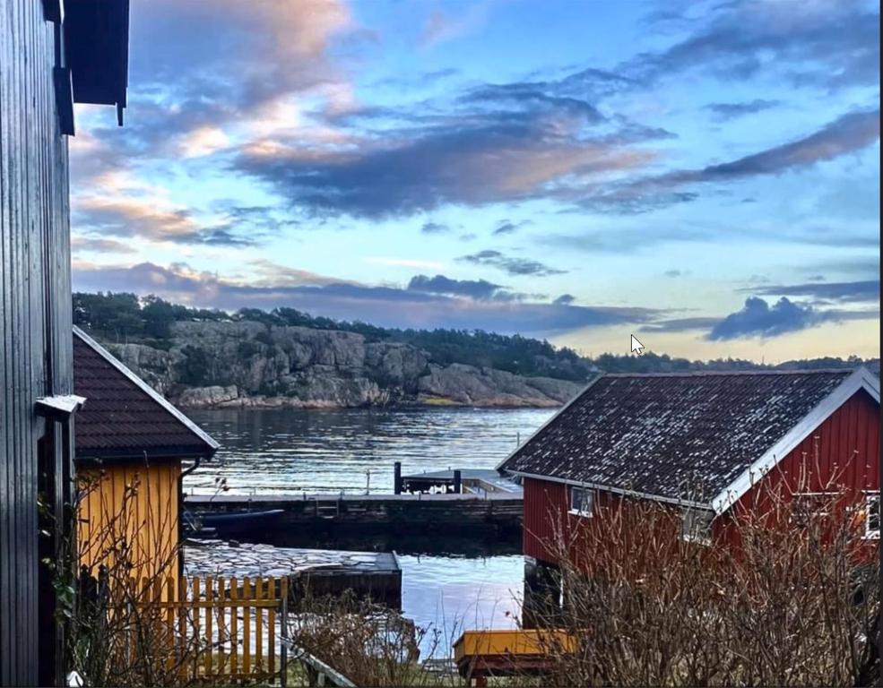 a view of a river with a red building and aarf at Lunvig Romantic country house by the sea in Kristiansand, Søgne in Kristiansand