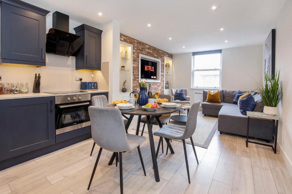a kitchen and living room with a table and chairs at York Luxury Apartments, Bishopthorpe Rd in York