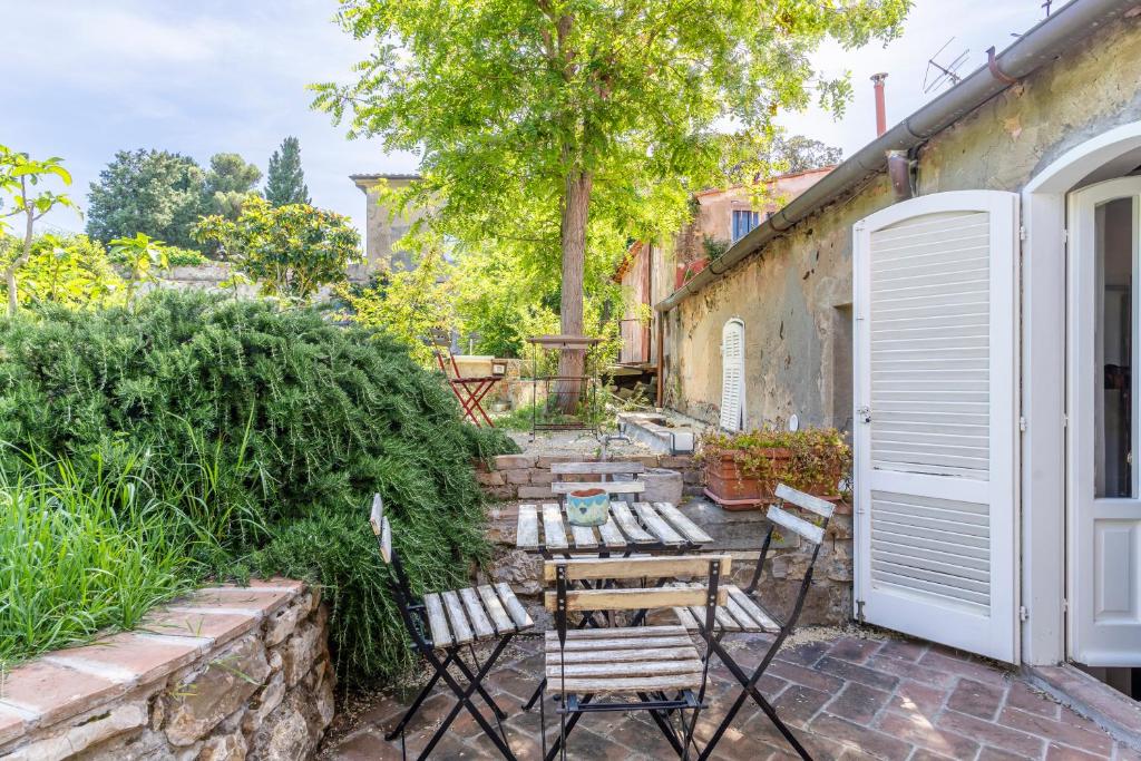 een patio met stoelen en een tafel in de tuin bij Country House With Garden&Private Parking! in Livorno