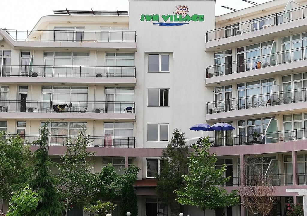 a building with a blue umbrella in front of it at Kims One-bed Apart for rent at Sunny Beach Resort in Sunny Beach