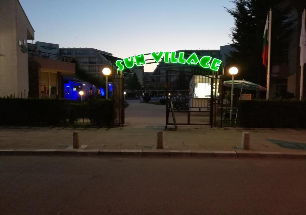 a neon sign that says sun village on a street at Kims One-bed Apart for rent at Sunny Beach Resort in Sunny Beach