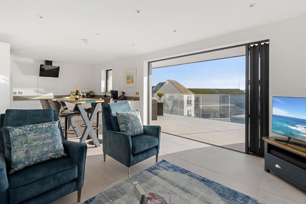 a living room with a view of the ocean at Estuary View, 3 Grand Banks in Teignmouth