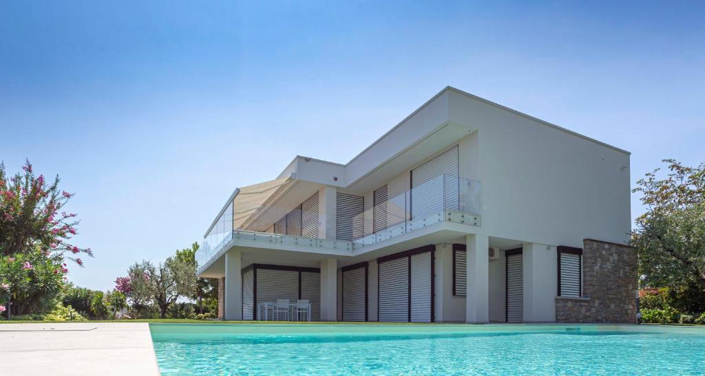 a house with a swimming pool in front of it at Villa degli Angeli in Soiano del Lago