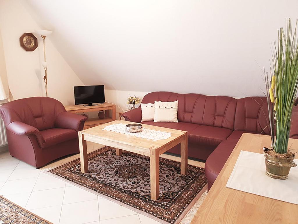 a living room with a couch and a coffee table at Friesenhain Ferienwohnungen in Sankt Peter-Ording