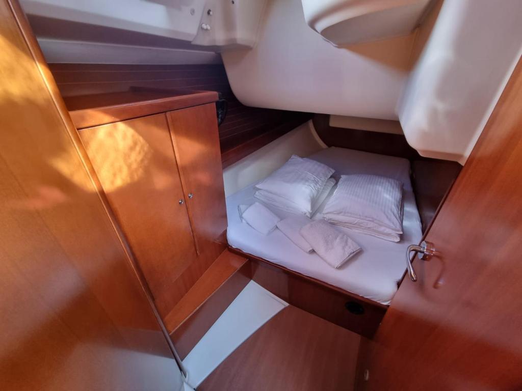 a small room with two white pillows on a boat at Sail boat ANIMATO in Izola