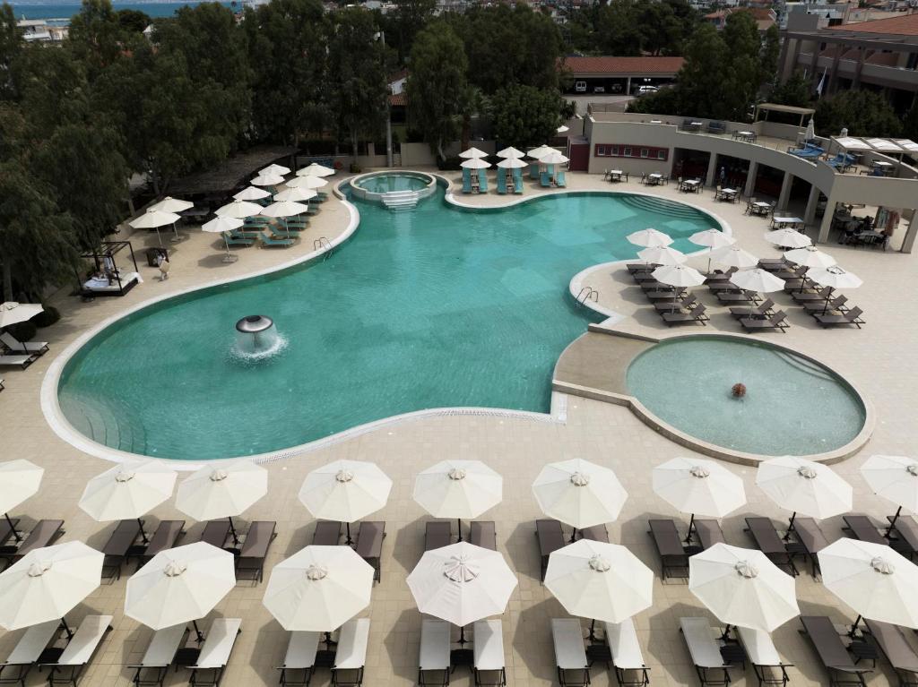 an overhead view of a swimming pool with umbrellas at Alkyon Resort Hotel & Spa in Vrahati