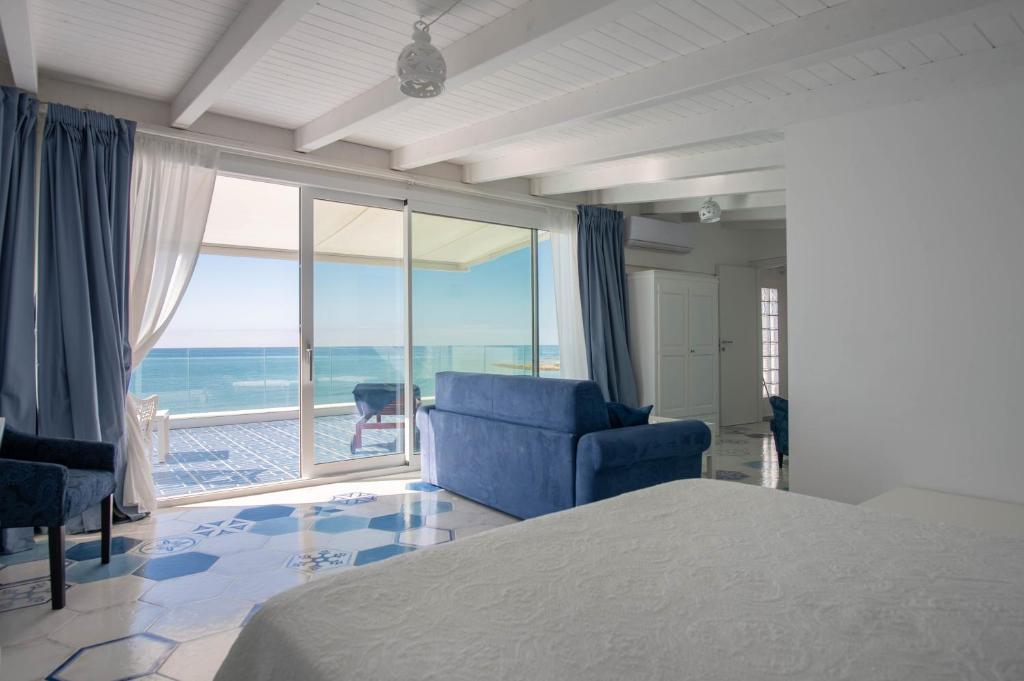 a bedroom with a bed and a view of the ocean at B&B Mammaliturchi SCALA DEI TURCHI in Realmonte