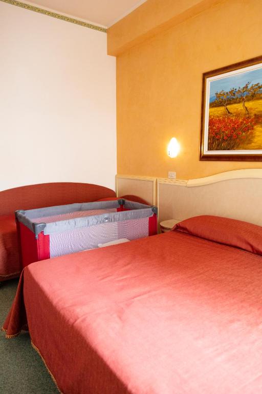 Postel nebo postele na pokoji v ubytování Hotel Igea Spiaggia