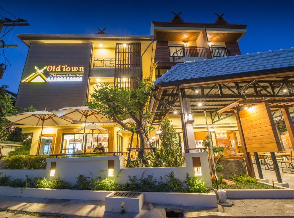 an exterior view of a hotel at night at Old Town Chiangmai Boutique in Chiang Mai