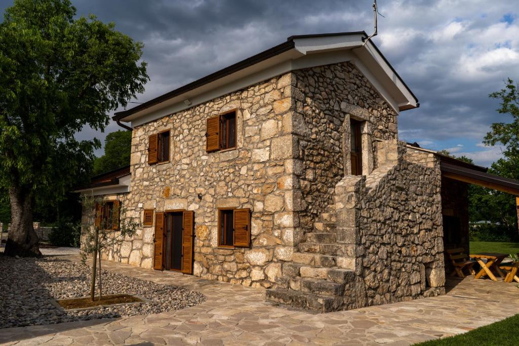 a stone building with a roof on top at Kamena Kuća Vegar in Ljubuški