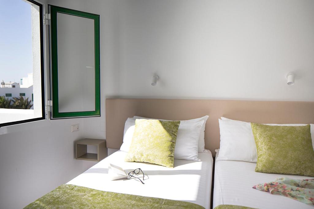 Postel nebo postele na pokoji v ubytování Apartamentos El Guarapo