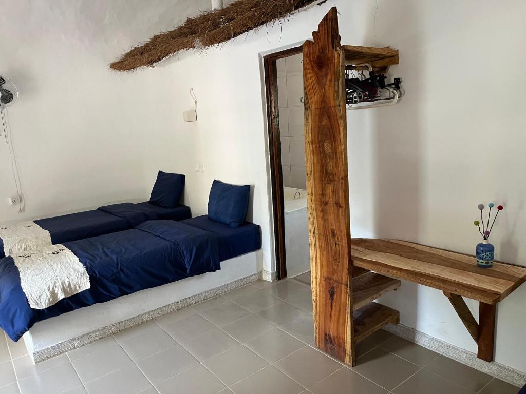 a room with two beds and a mirror in it at Footsteps Eco-Lodge in Gunjur