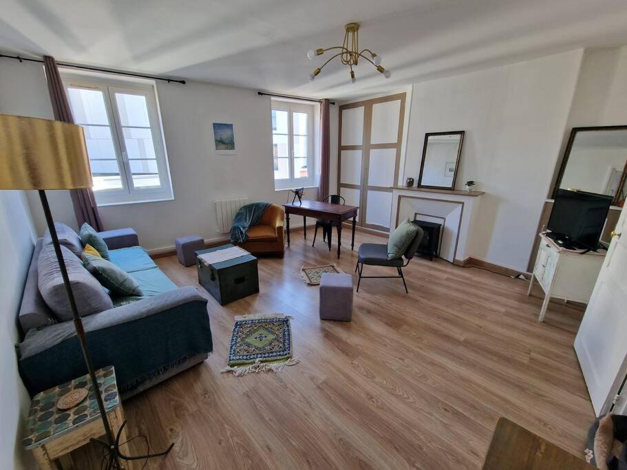 un salon avec un canapé et une cheminée dans l'établissement Le Carillon Dieppois, à Dieppe