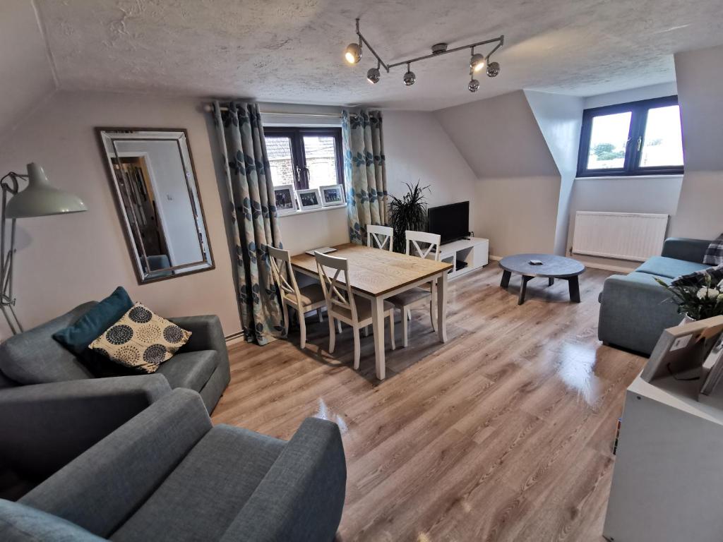 a living room with a couch and a table at Spacious Family Friendly Apartment- 100m from beach with Seaviews! in Hunstanton