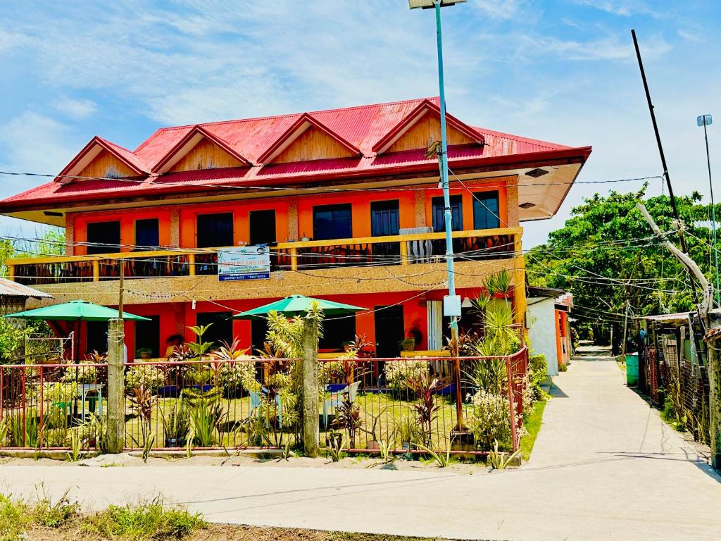 a red building with a red roof at Edem Tourist Inn Malapascua in Malapascua Island