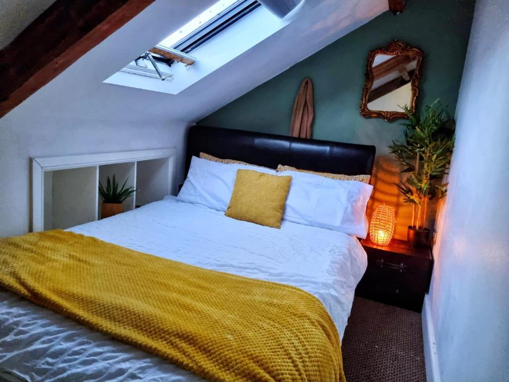 a bedroom with a bed with a yellow blanket at Safire home in Murton