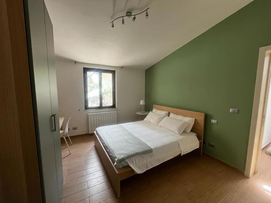 una camera con un letto con una parete verde di Casa ideale per la tua vacanza a Pescara