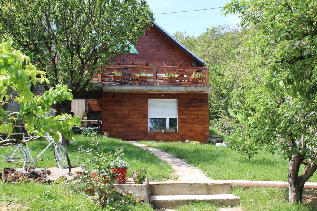 a brick house with a balcony on top of it at Buzzing Retreat in Velika Remeta
