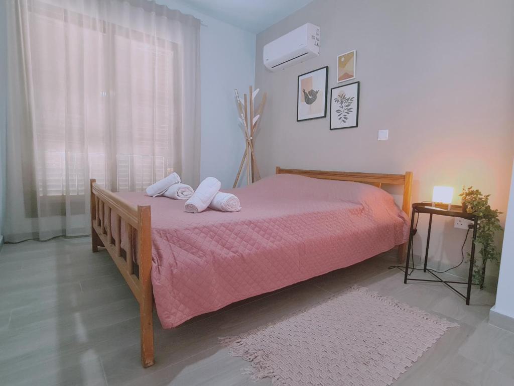 a bedroom with a bed with two pillows on it at STAY BelleVue Apartment in Khlorakas