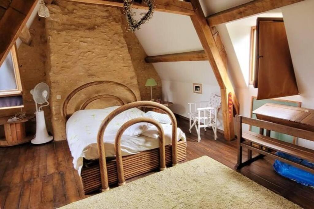 a bedroom with a large bed in a room at Maison périgourdine avec vue et piscine chauffée in Peyzac-le-Moustier