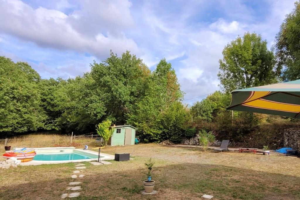 a backyard with a swimming pool and a tent at Maison périgourdine avec vue et piscine chauffée in Peyzac-le-Moustier