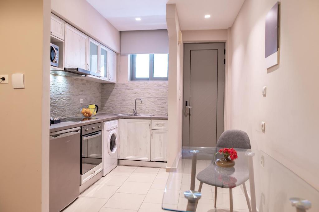 a kitchen with a glass table and a sink at Aspa Holidays in Kos Town