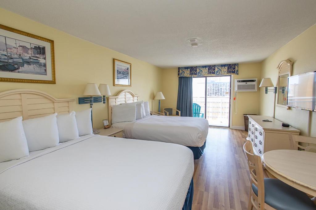 um quarto de hotel com duas camas e uma mesa em Sea Mist 51001 em Myrtle Beach