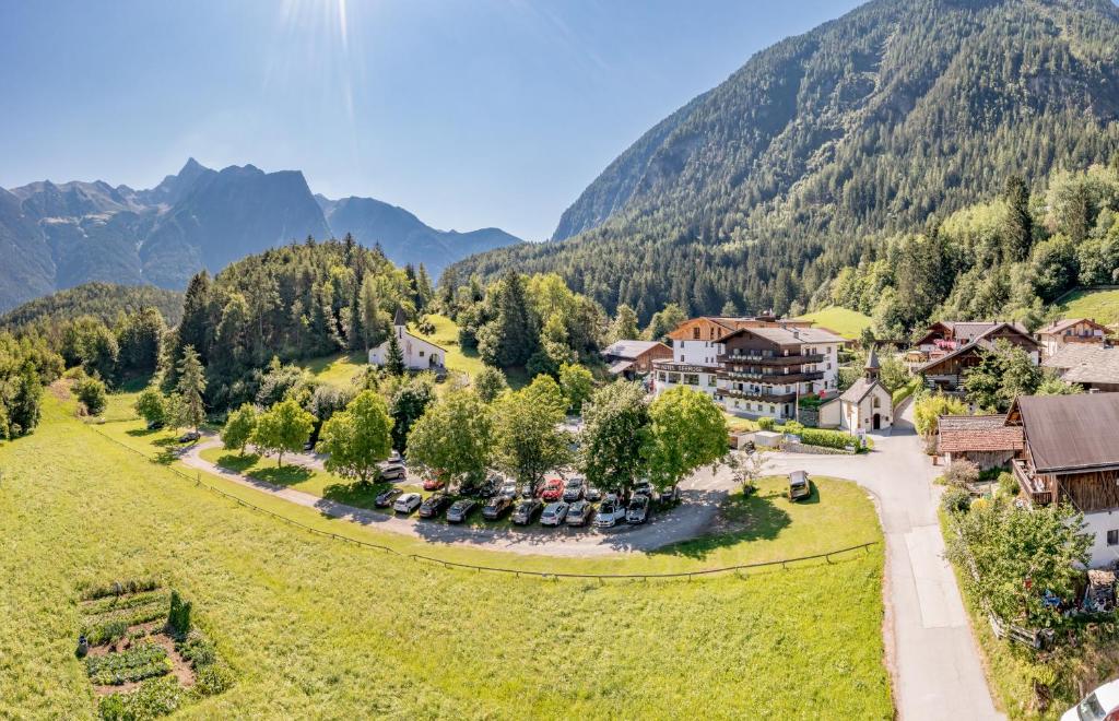an aerial view of a resort with mountains in the background at Seehüter's Hotel Seerose in Oetz