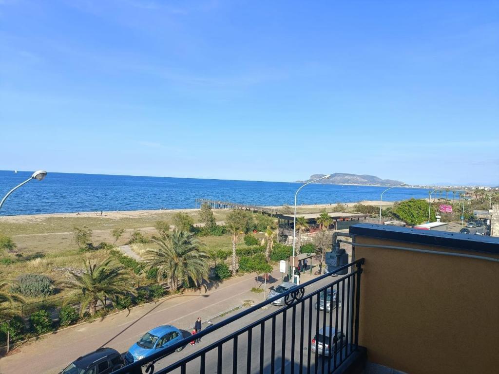 a balcony with a view of a street and the ocean at Casa Josè Suite Mare in Palermo