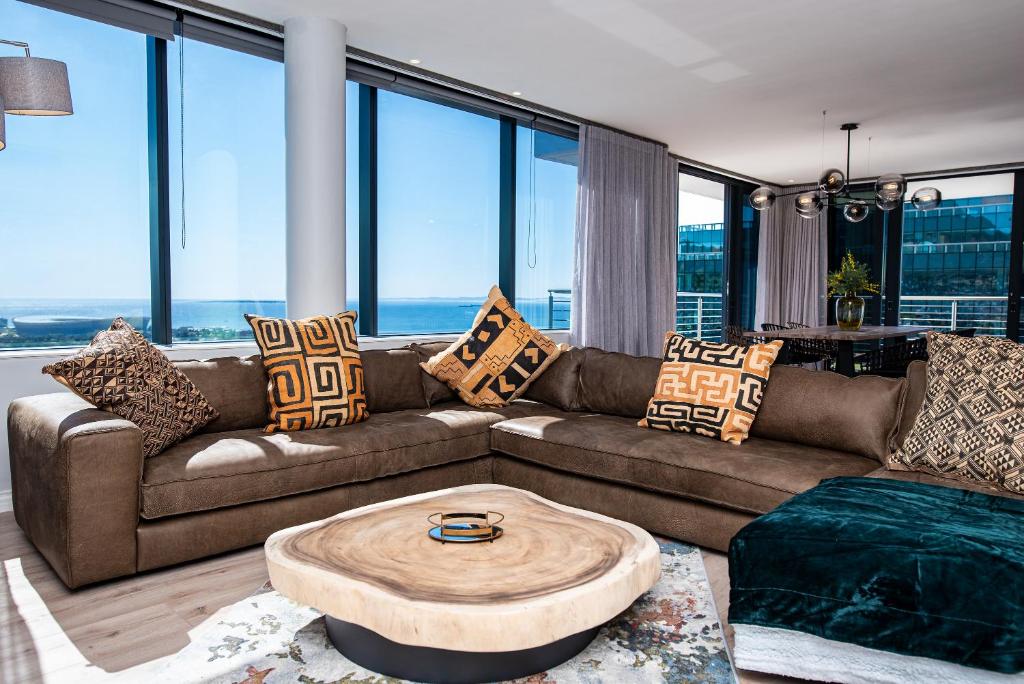 a living room with a couch and a table at Magnificent penthouse with breathtaking views in Cape Town
