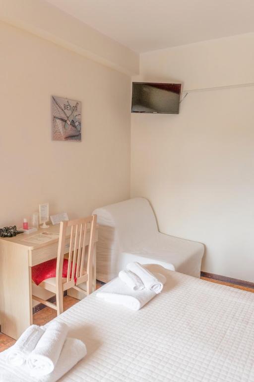 Postel nebo postele na pokoji v ubytování Hotel Maxim