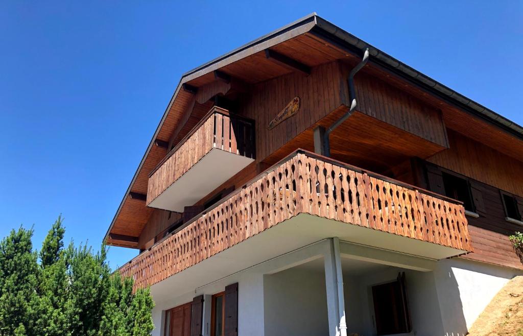 a building with a balcony on the side of it at Chalet Letach - 'Great Bike Park Access' relax around the fire pit, mountain retreat in Châtel