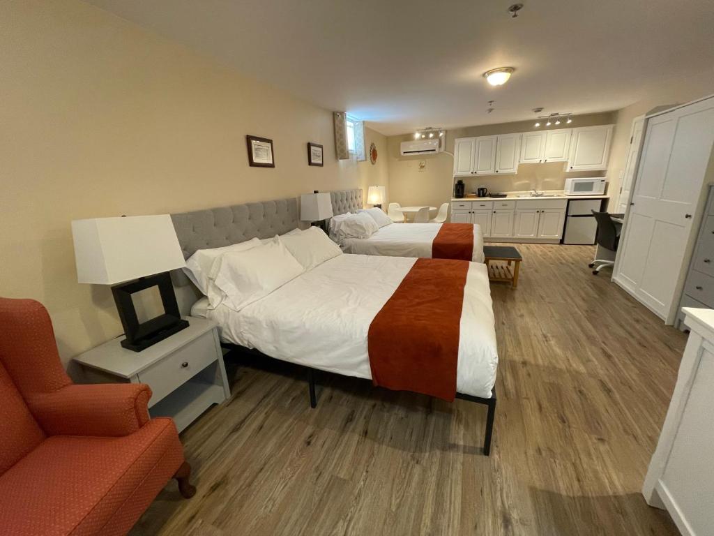 a large bedroom with two beds and a kitchen at The Harbour House in Charlottetown