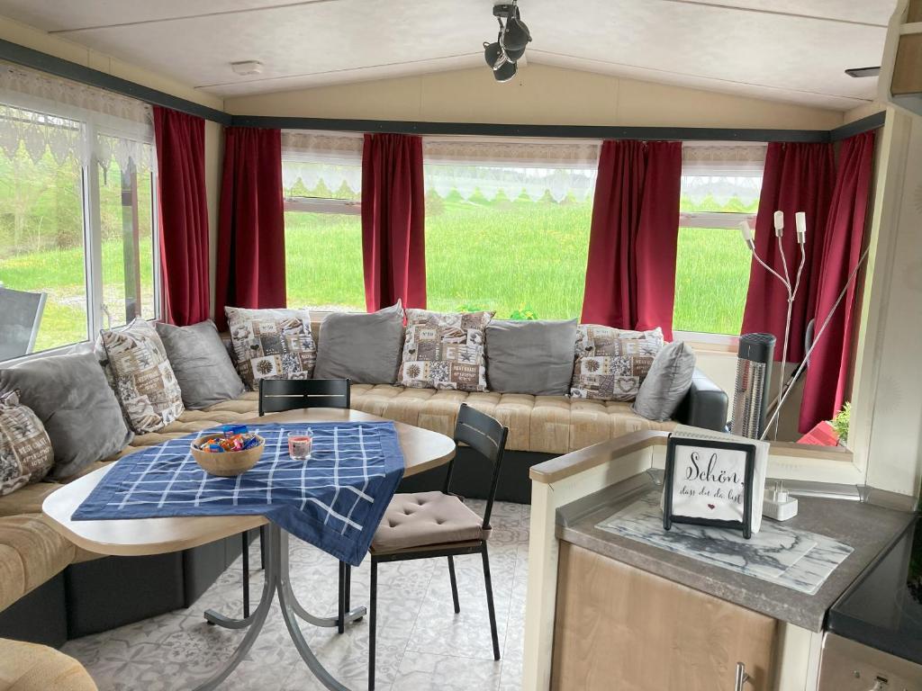 a living room with a couch and a table at Ring Chalet in Brücktal