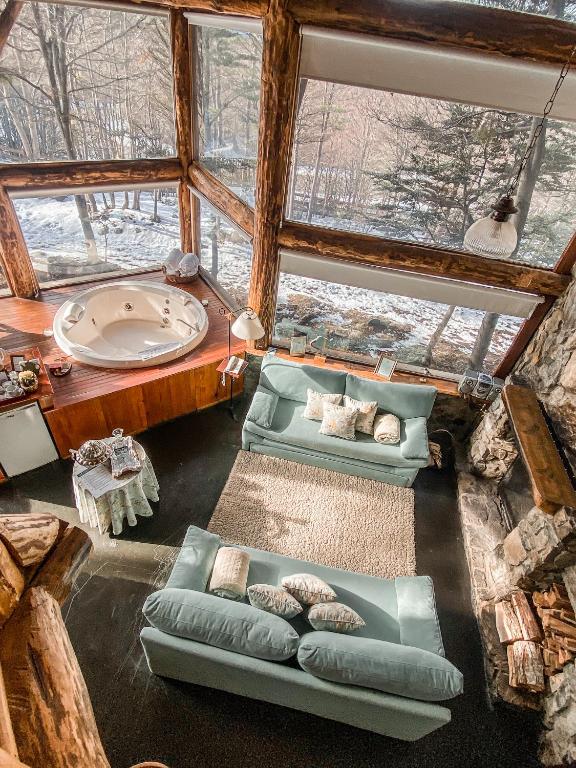 a living room with couches and a large window at Cumbres Del Martial in Ushuaia