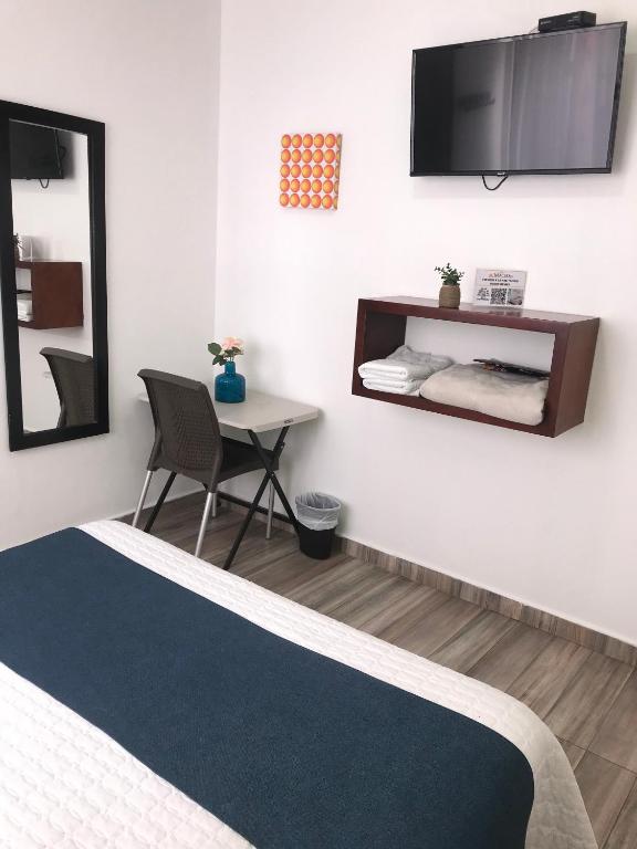 TV a/nebo společenská místnost v ubytování Hotel Maceo 55 - Colonial Inn