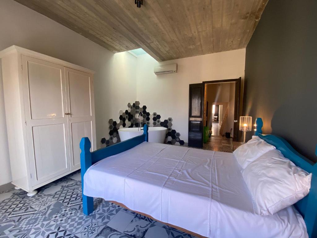 a bedroom with a blue bed in a room at Sliema Distant Seaview Penthouse in Sliema
