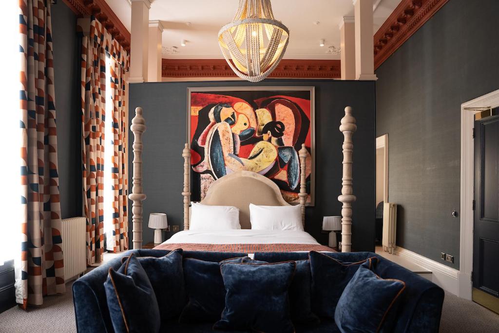 a bedroom with a bed with a painting on the wall at Milsom Hotel Bath in Bath