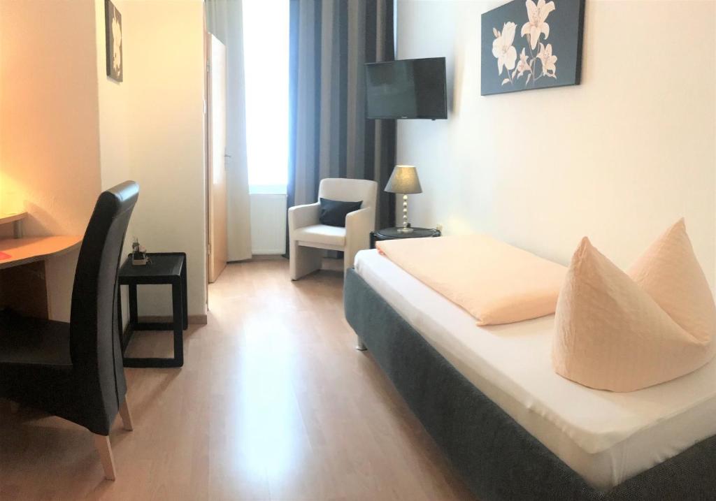 Postel nebo postele na pokoji v ubytování Hotel Antoni
