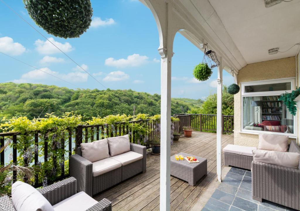 a porch with a view of the mountains at Lindos in Looe