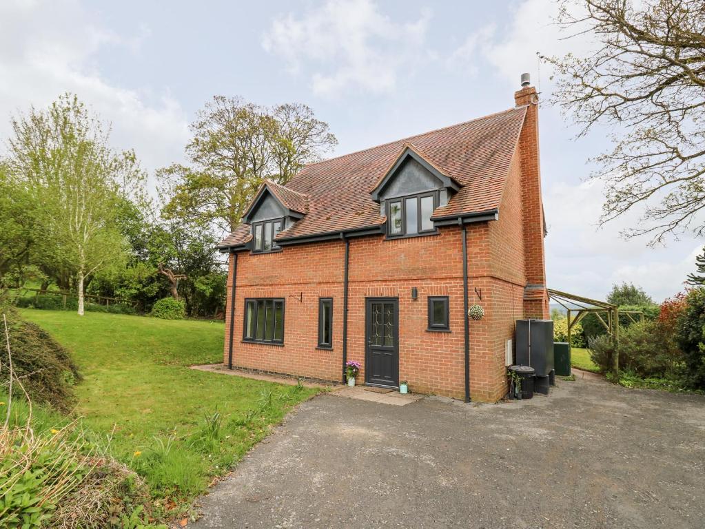 an old brick house with a driveway at Applecroft in Coreley