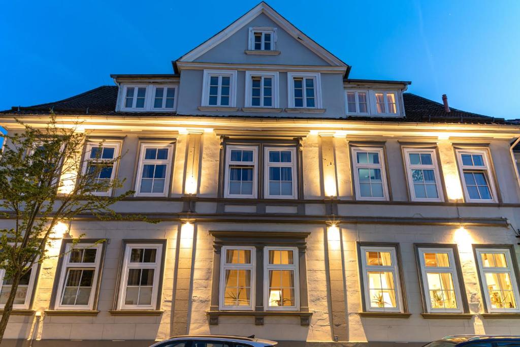 a large white building with lights on it at Hotel Kaiserhof in Goslar