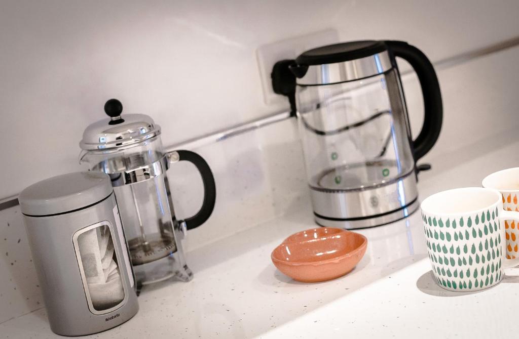 a kitchen counter with a blender and a coffee pot at King’s Road Apartments in Harrogate