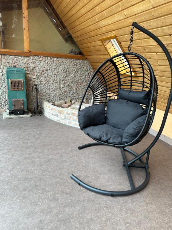 a swing chair sitting in the middle of a room at Kuzey Apartments in Kappel-Grafenhausen