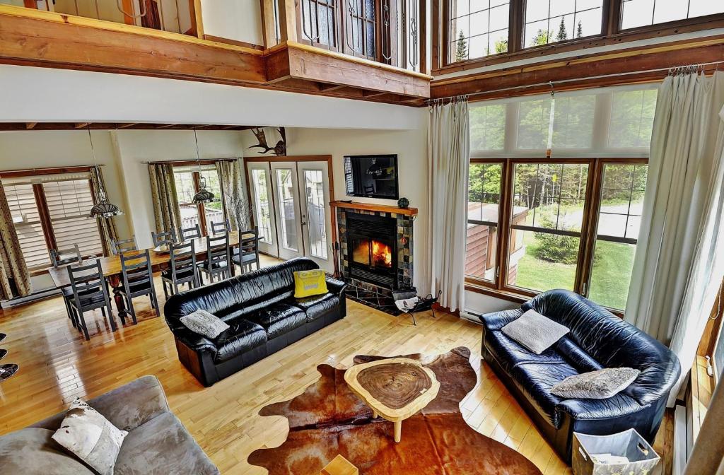 a living room filled with furniture and a fireplace at 9020 Chemin des Alpages in Stoneham