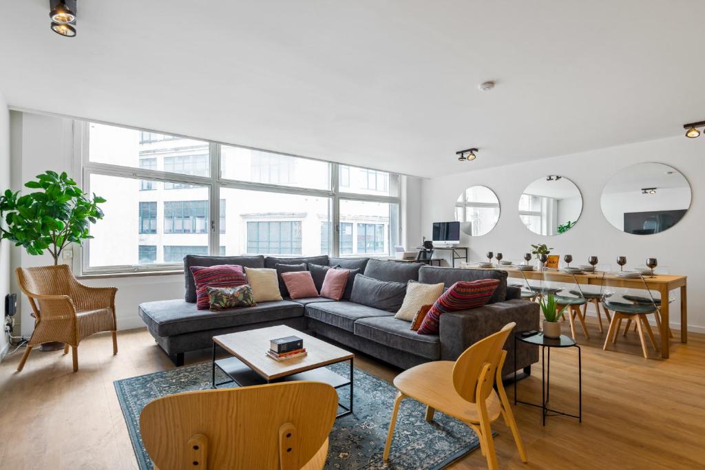 a living room with a couch and a table at Cozy Antwerp - Cityview Family Apartment FREE PARKING in Antwerp